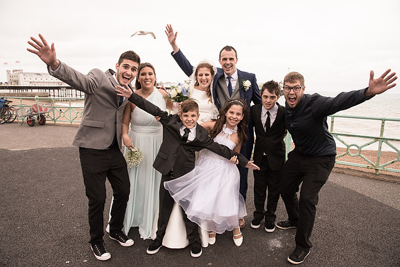 Wedding Party Having Fun by the Palace Pier Brighton Sussex